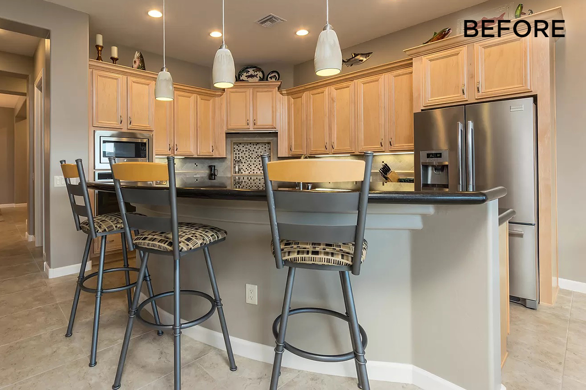 A before image of a kitchen with grey paint and light brown cabinets.
