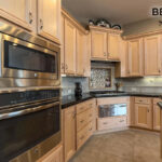 A close up of the before, showing the oven built into the wall and the cabinets close up.