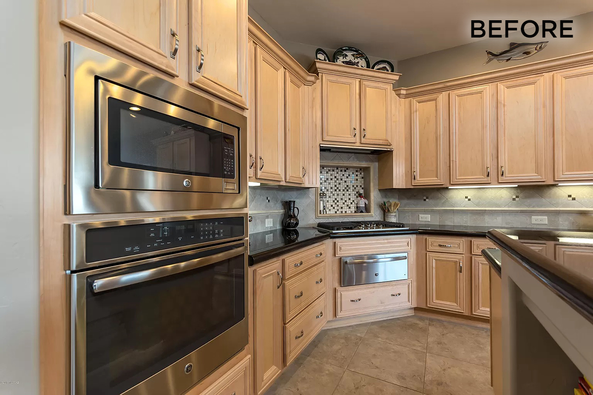 A close up of the before, showing the oven built into the wall and the cabinets close up.