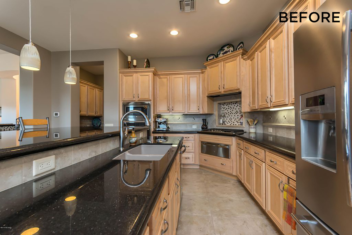 Another angle of the before showing the island with the kitchen sink and black countertops.