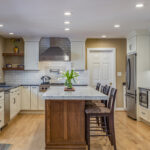 warm stained island and white kitchen cabinets