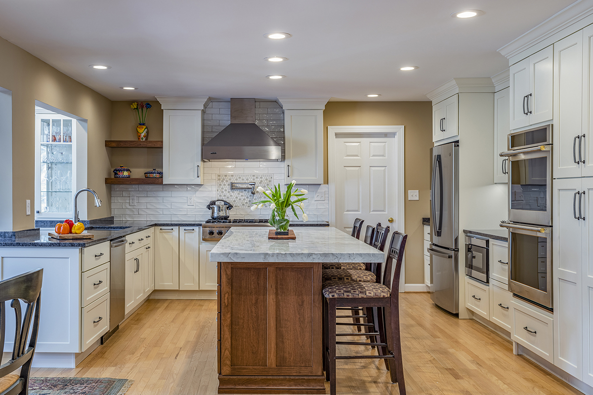 warm stained island and white kitchen cabinets