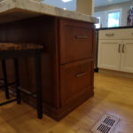 warm stained and white kitchen cabinets