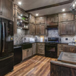 Washed cabinets with weathered backsplash in smaller kitchen.