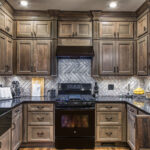 a view of the sink and stove with the cabinets and molding in the Brotzman kitchen