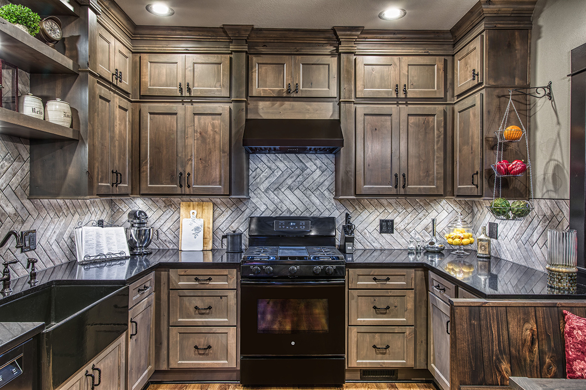a view of the sink and stove with the cabinets and molding in the Brotzman kitchen