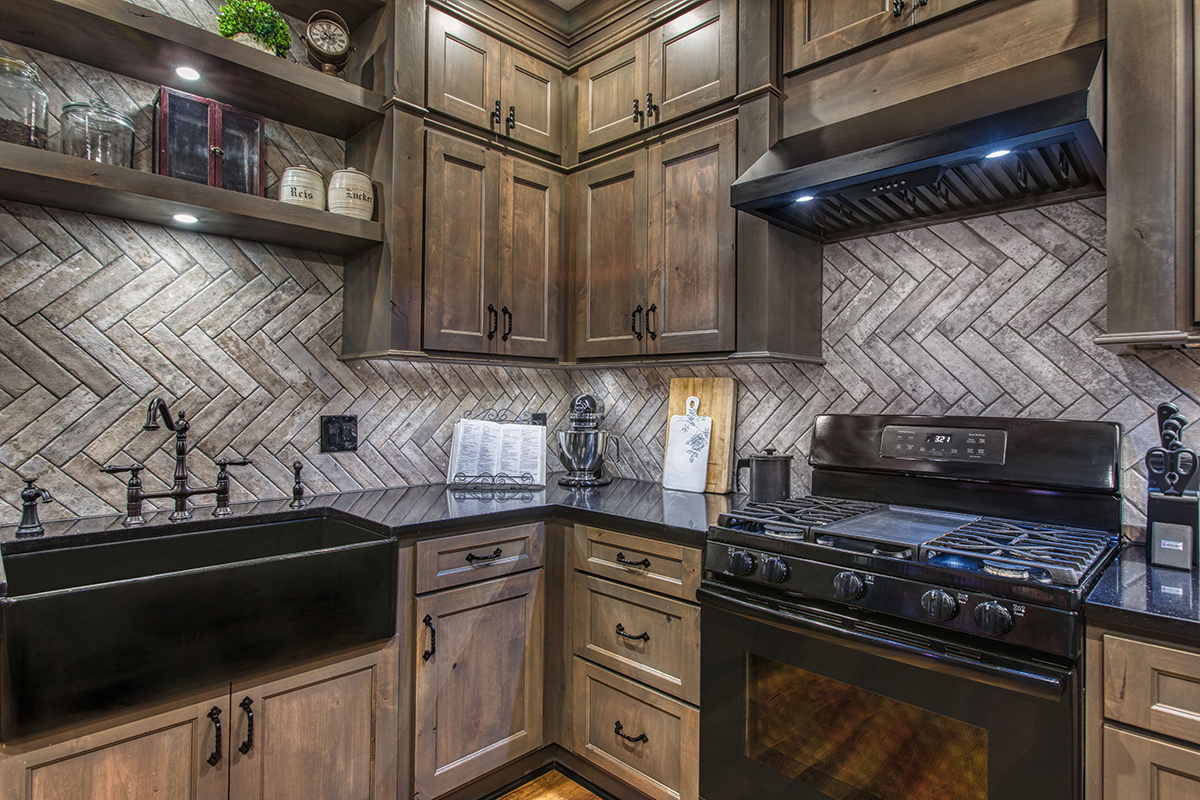 view of the open shelving above the kitchen sink with decorations.