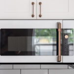 Shows the microwave with the custom gold handle.