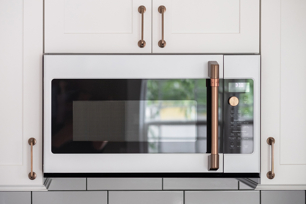 Shows the microwave with the custom gold handle.