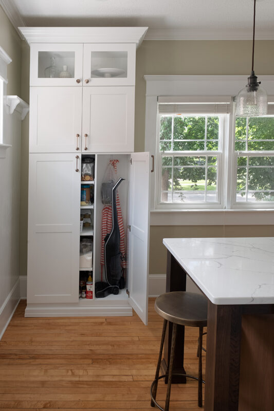 Built in pantry at the edge of the kitchen.
