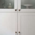 shows the decorate glass-front cabinets at the top of the kitchen