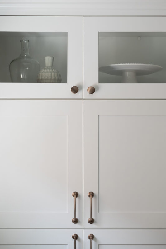 shows the decorate glass-front cabinets at the top of the kitchen