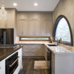 Shows internal side of cabinets with kitchen sink and granite counters.