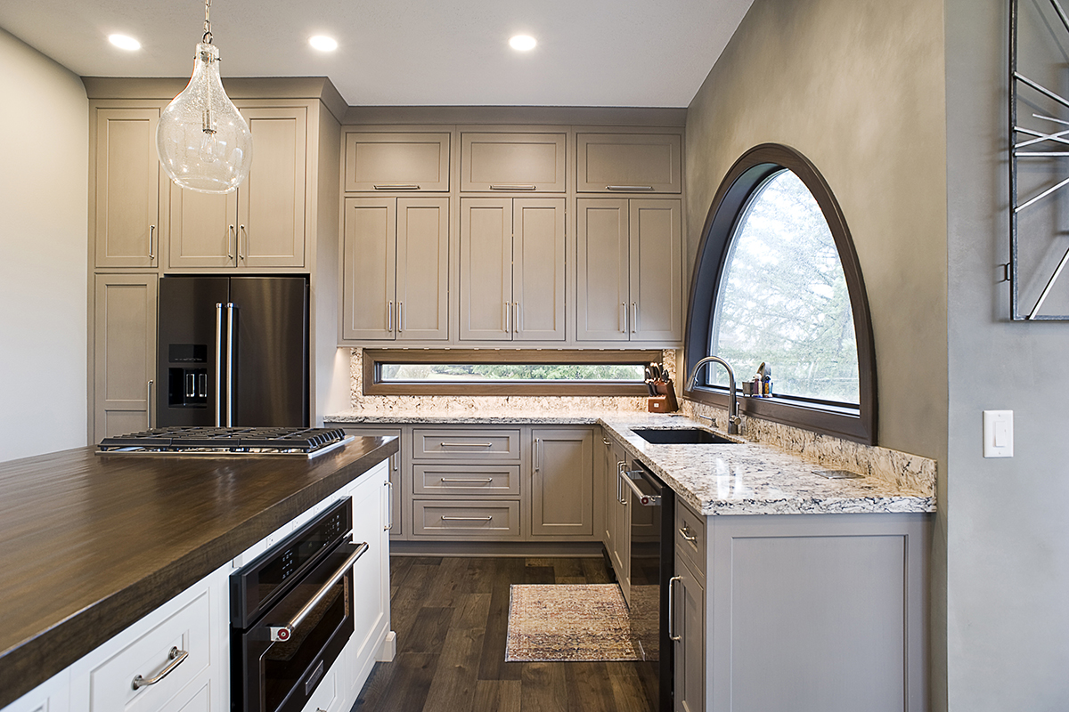 Shows internal side of cabinets with kitchen sink and granite counters.