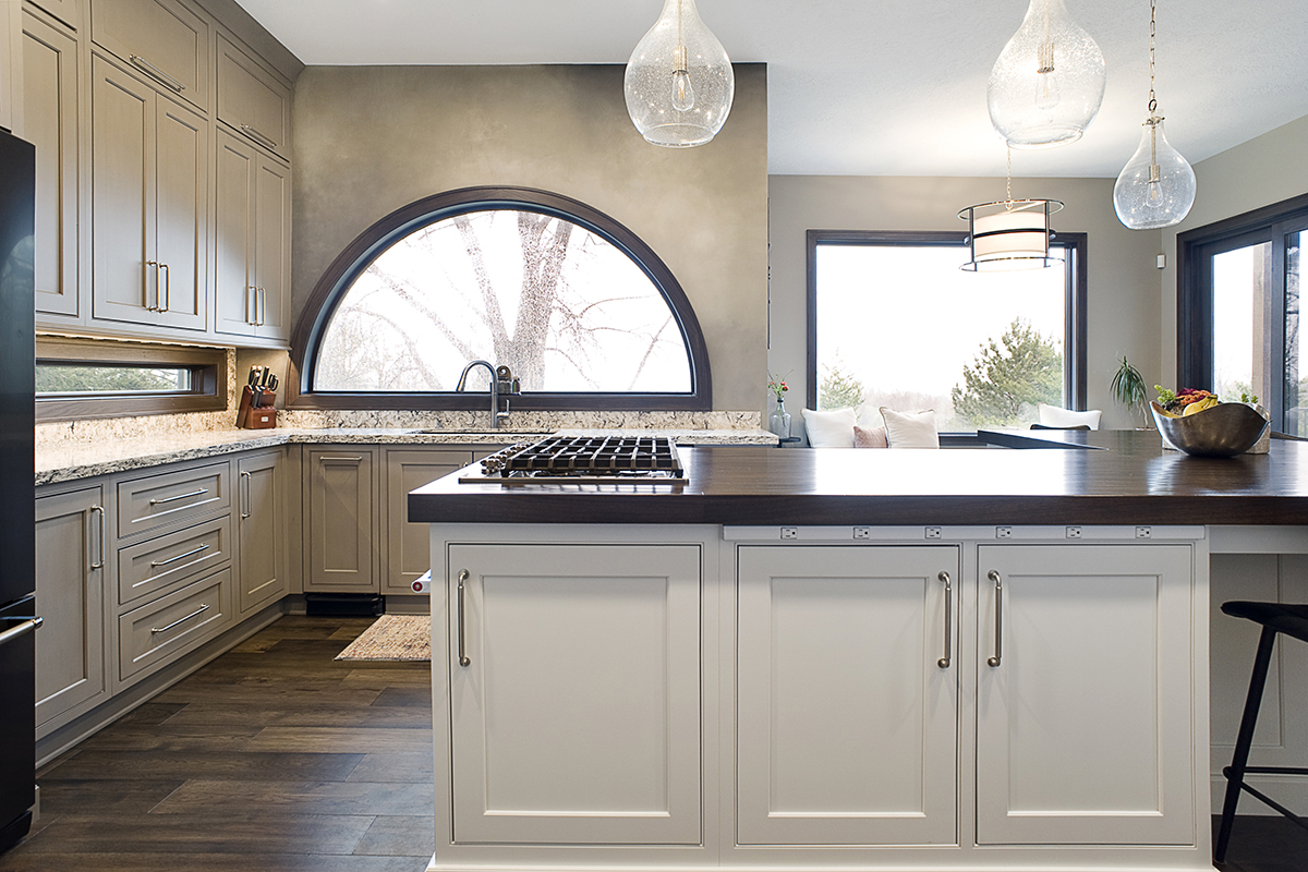 shows range on middle island with the white cabinets around the range.