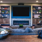 family room view of built in shelving with around the tv and fireplace