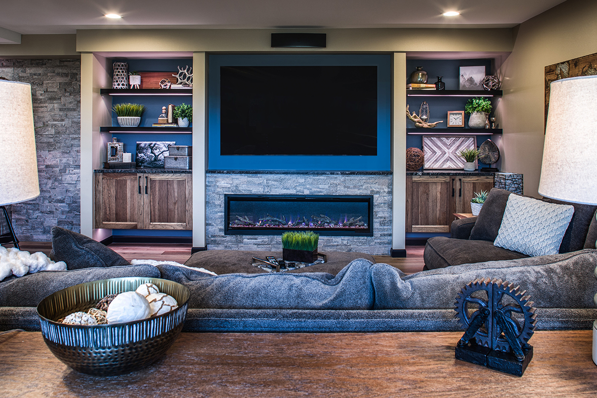 family room view of built in shelving with around the tv and fireplace