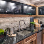 Up close shot of the cabinets, sink, and countertops.