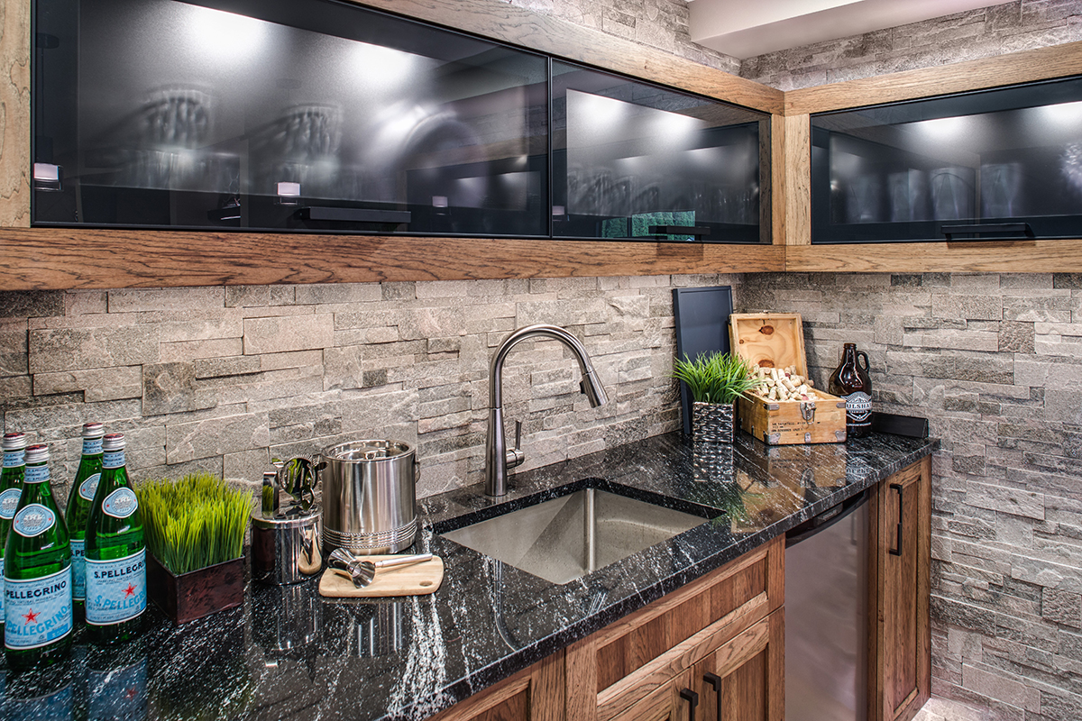 Up close shot of the cabinets, sink, and countertops.