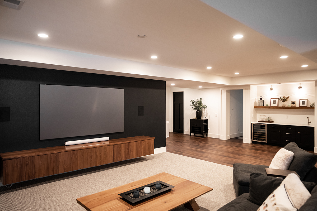 Another view of the walnut built in entertainment center with a view of the wine fridge in the family room.