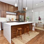 Walnut cabinets with white countertop bar.