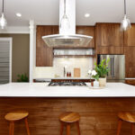 Closer view of the island with the range hood over the island.