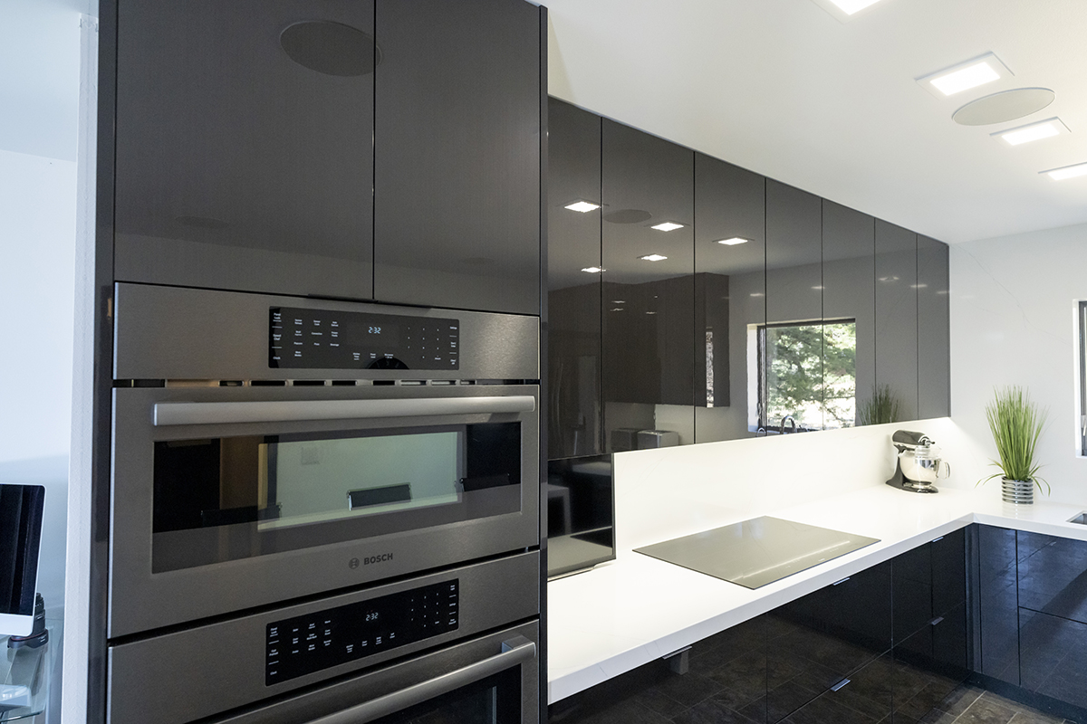 Dark grey cabinets close up of ovens that are built into the wall.