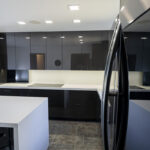 Shows the dark cabinets and white countertops