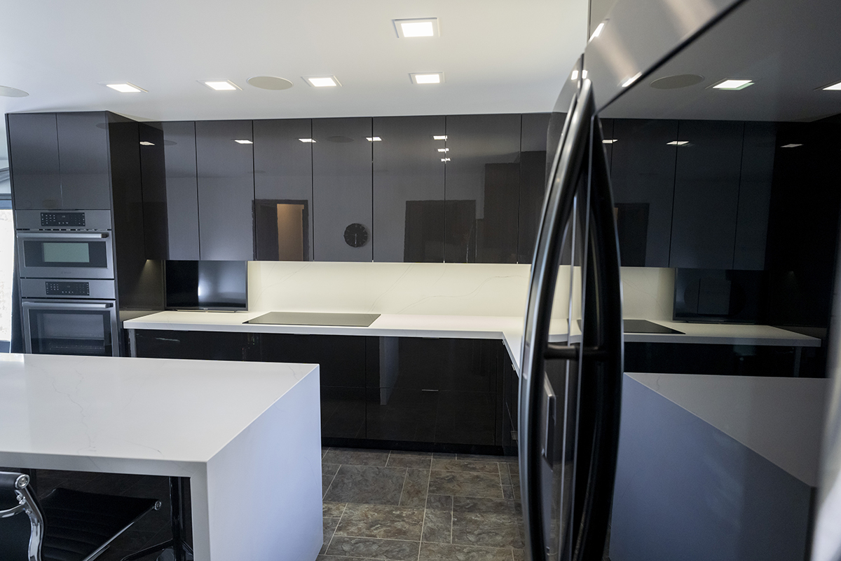 Shows the dark cabinets and white countertops