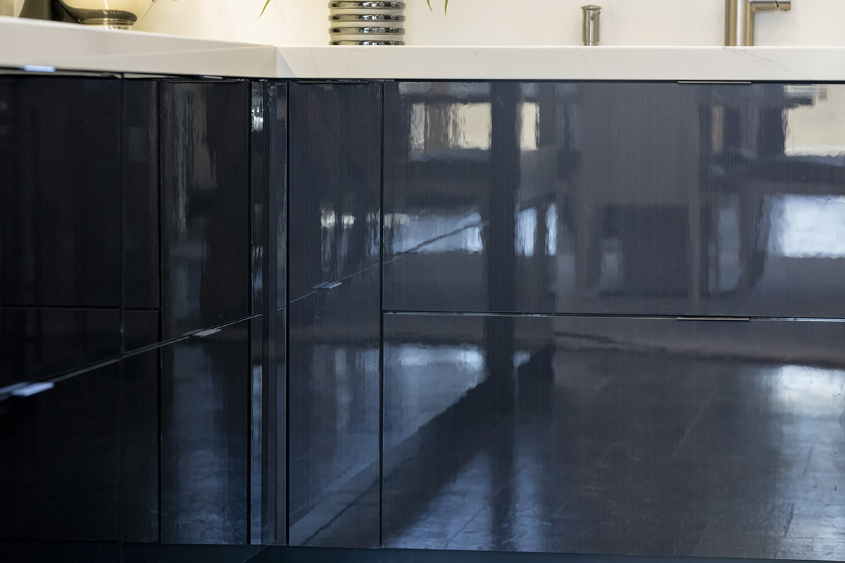 A close up of the lower cabinets that shows how glossy the cabinets are.