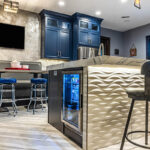 We see a beverage cooler built into the island.