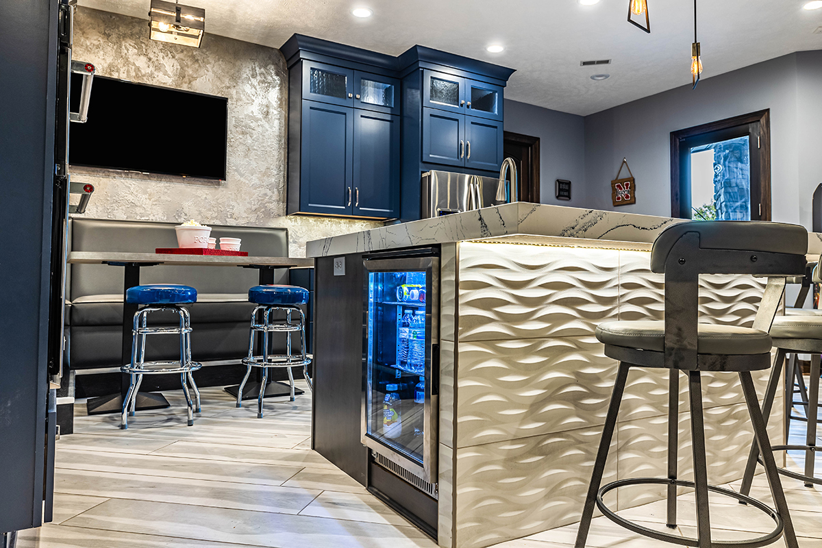 We see a beverage cooler built into the island.