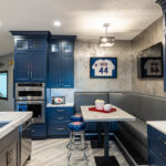 The stainless steel stove is built into the wall. The right hand of the photo shows the big booth.