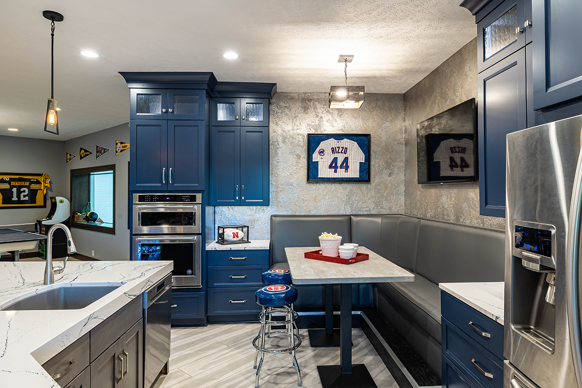 The stainless steel stove is built into the wall. The right hand of the photo shows the big booth.
