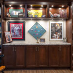 In the sports bar there are built-in shelving units that contain sports memorabilia.