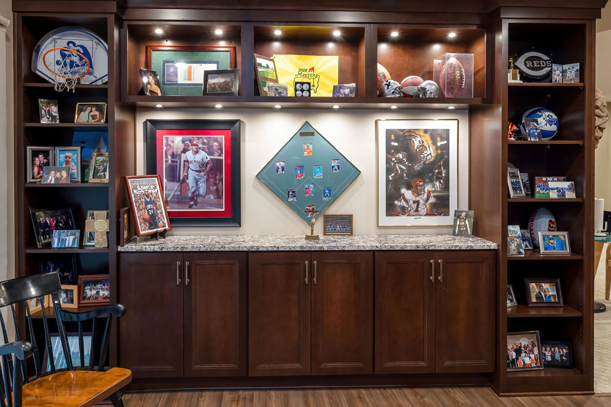 In the sports bar there are built-in shelving units that contain sports memorabilia.