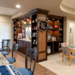 Dual sided built in shelving with the features of the sports teams and family photos.