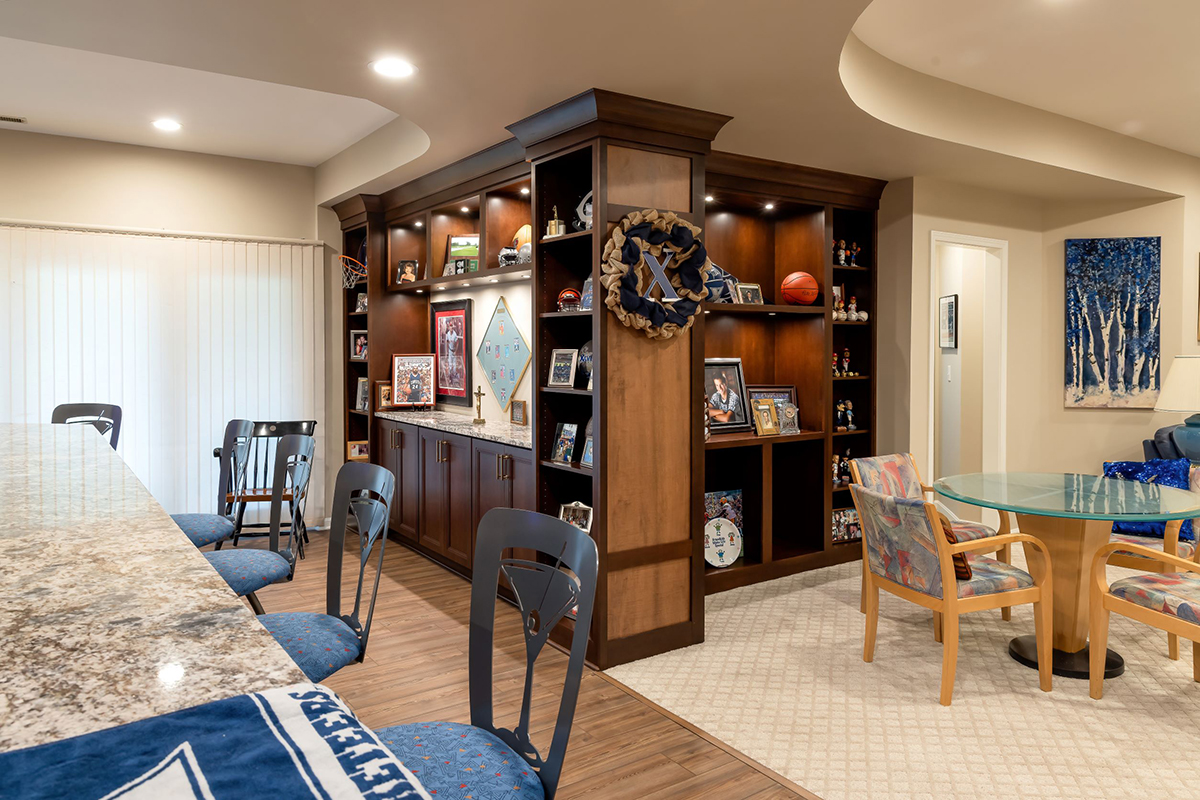 Dual sided built in shelving with the features of the sports teams and family photos.
