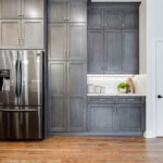 Shows the fridge and large pantry cabinets that are floor to ceiling.