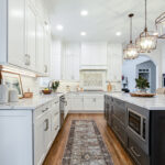 Shows the distance between the back wall of cabinets and the dark island.