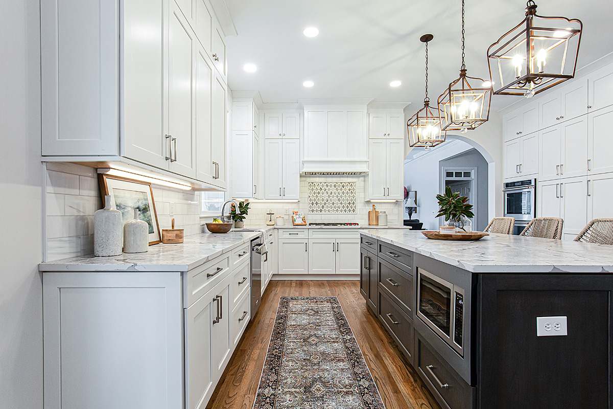 Shows the distance between the back wall of cabinets and the dark island.