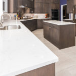 brown kitchen cabinets with white counter tops in large diagonal kitchen