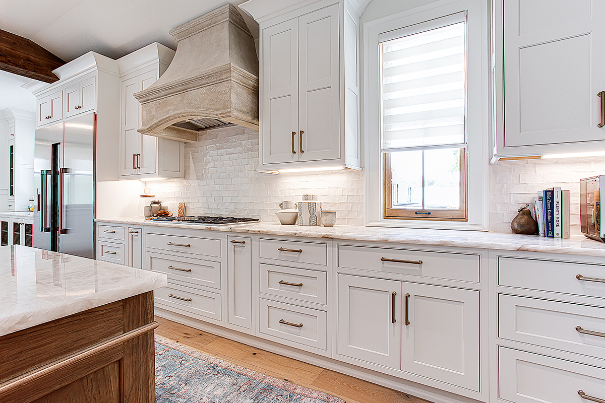 White cabinets with gold hardware.
