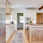 White cabinets with hickory island.