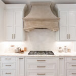 White cabinets with a beige oven hood.