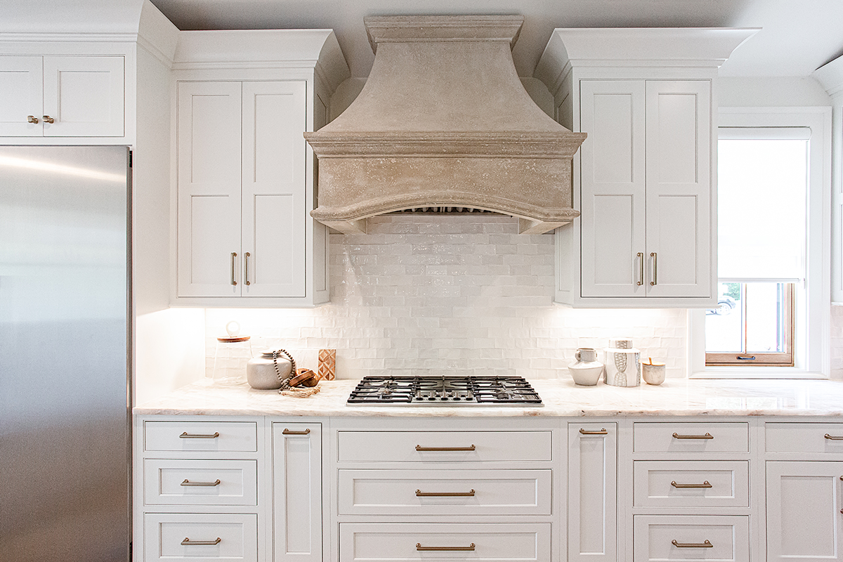 White cabinets with a beige oven hood.