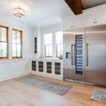 Large commercial kitchen fridge with built-in cabinets.