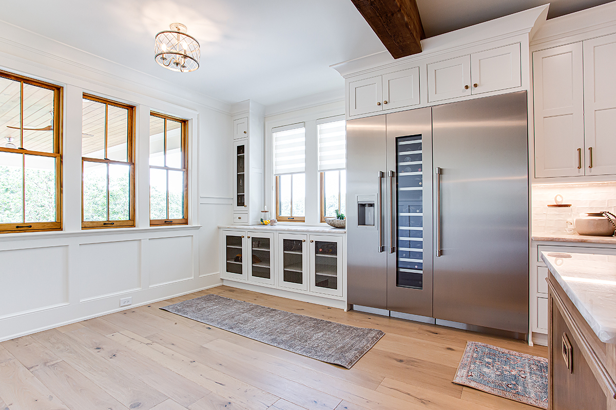 Large commercial kitchen fridge with built-in cabinets.