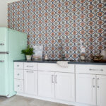 Another view of the white cabinets with the blue-green vintage fridge.