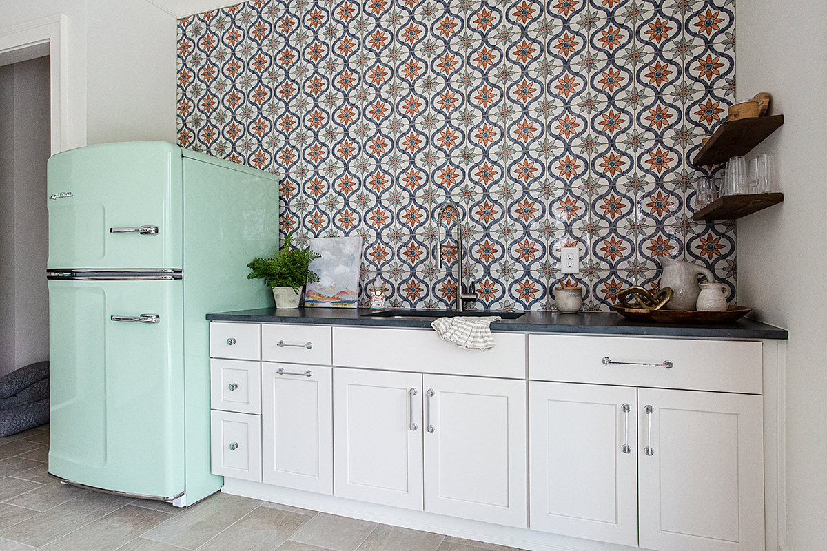 Another view of the white cabinets with the blue-green vintage fridge.
